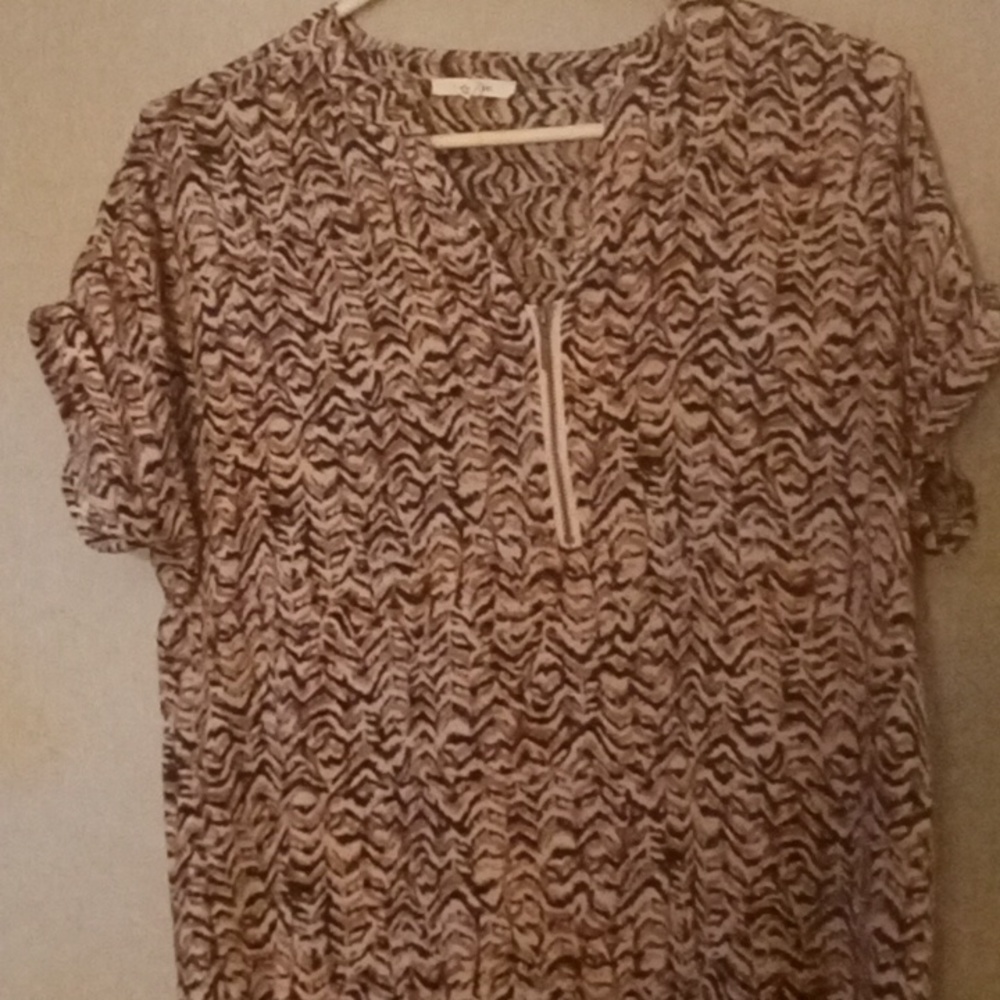 A short sleeve zip up front blouse